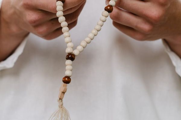 Close-up of hands in a meditative gesture.